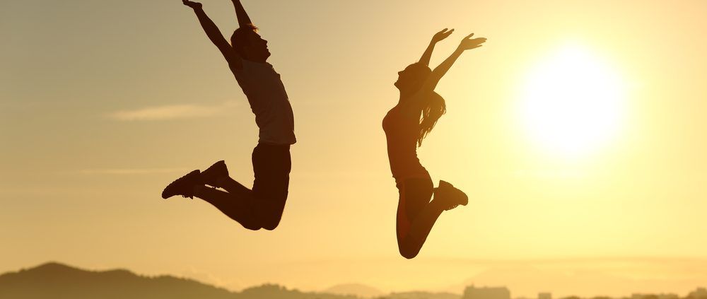 man and woman jumping